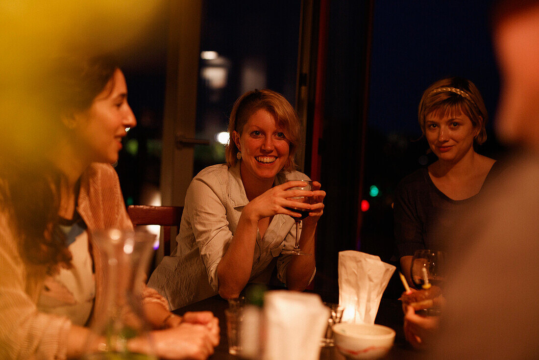 Happy female friends enjoying birthday party at home