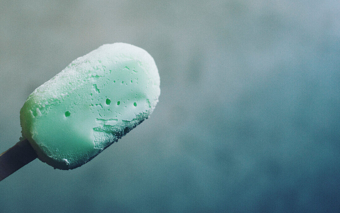 Close-up of green ice cream on stick