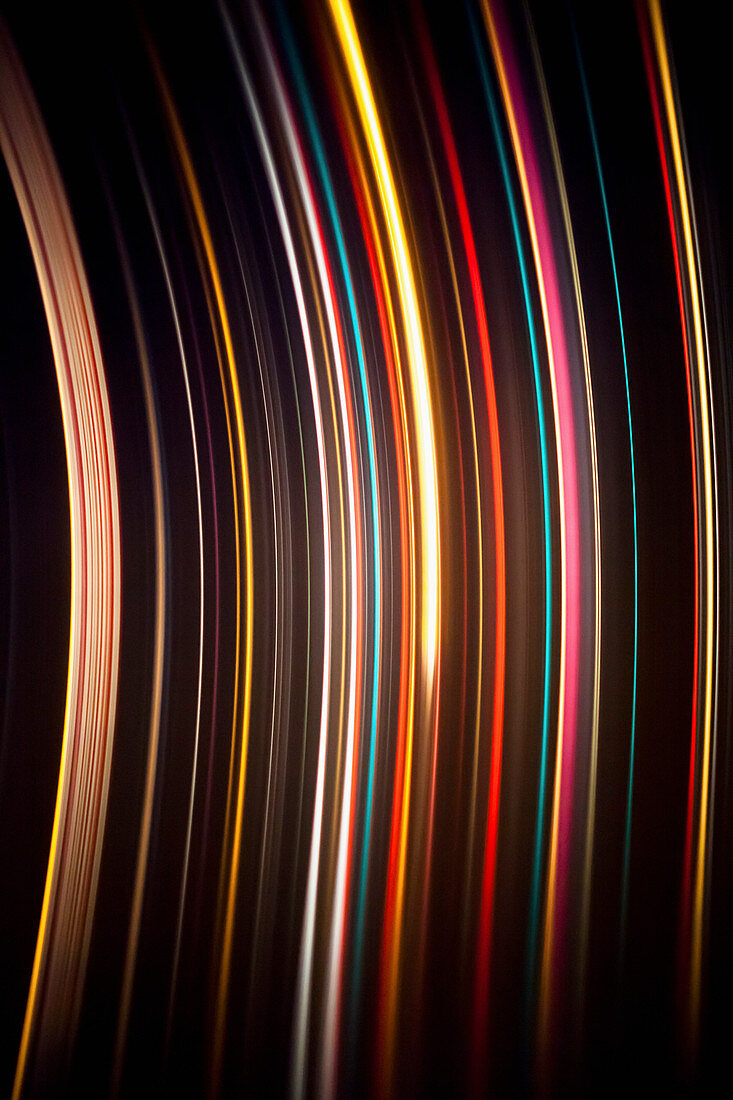 Abstract image of colorful light trails against black background