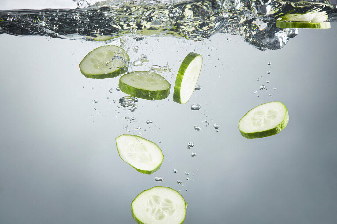 Close-up of cucumber slices in splashing water