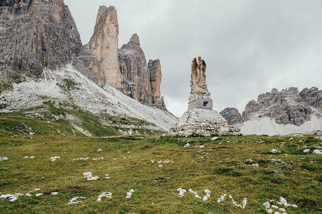 Weathered statue by stack rocks against sky, South Tyrol, Italy