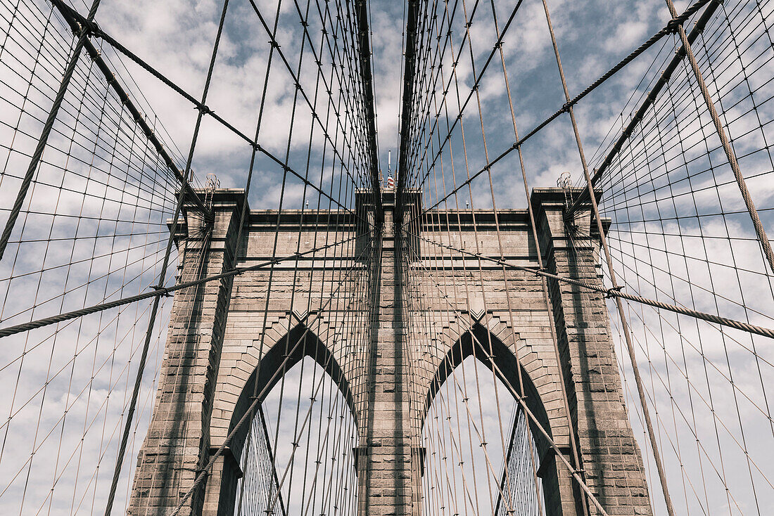 Low angle view of steel cables on Brooklyn Bridge against sky, New York City, New York, USA