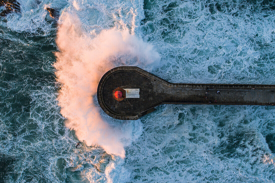 Directly above view of wave splashing on pier in sea, Porto, Portugal
