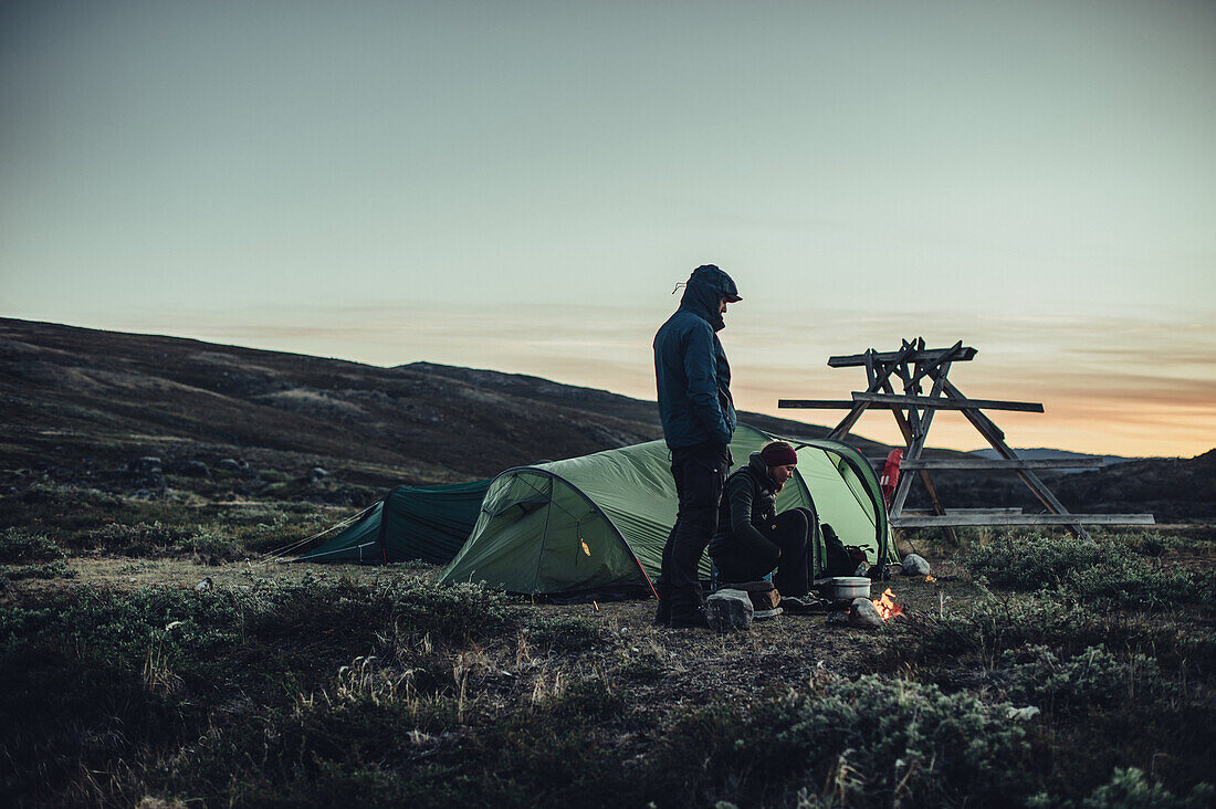 Hiker in front of two tents in greenland, greenland, arctic.