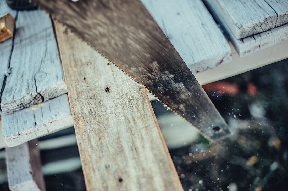 A saw cutting wood, greenland, arctic.