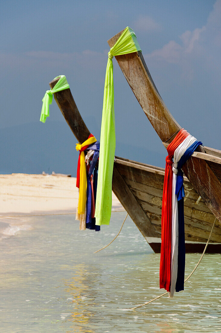 traditional colorful  cloths on the bow of a longtailboat at Poda beach, Andaman sea, Krabi, Thailand