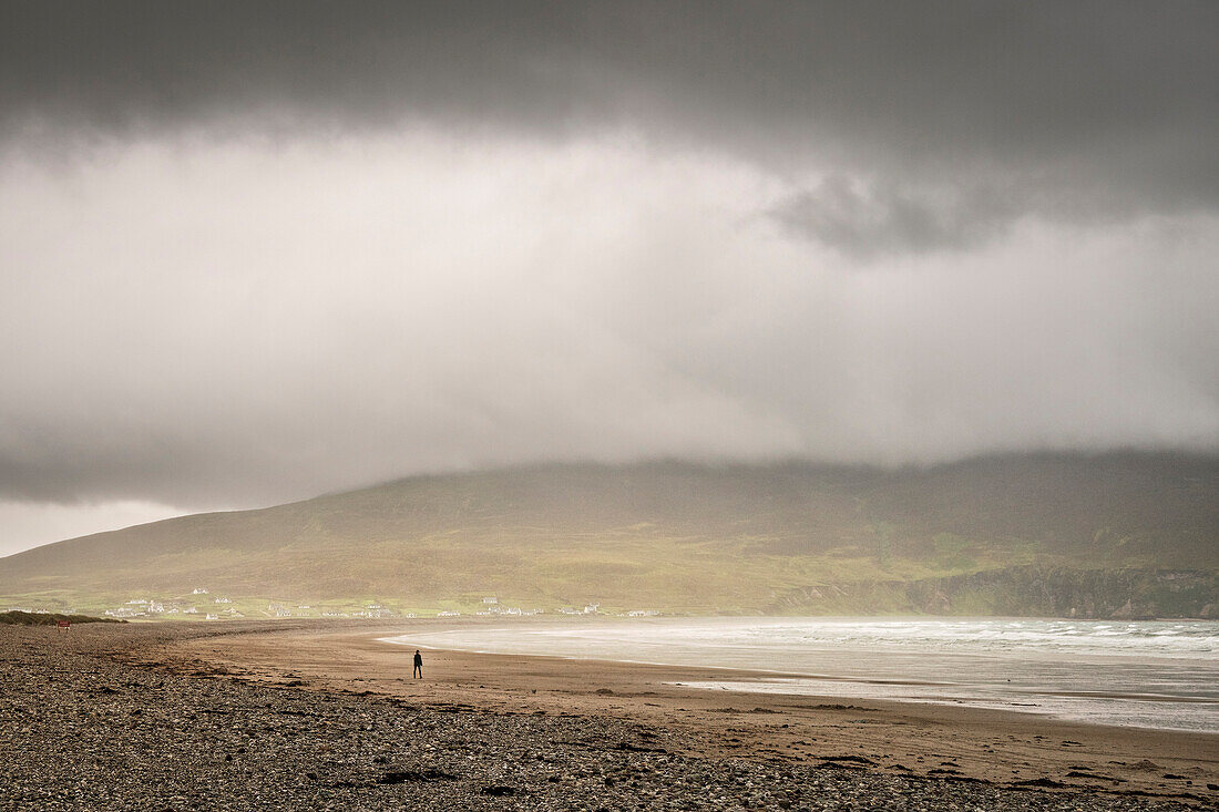 lonesome stroller while raining at Keel Beach, Achill Island, County Mayo, Ireland, Wild Atlantic Way, Europe