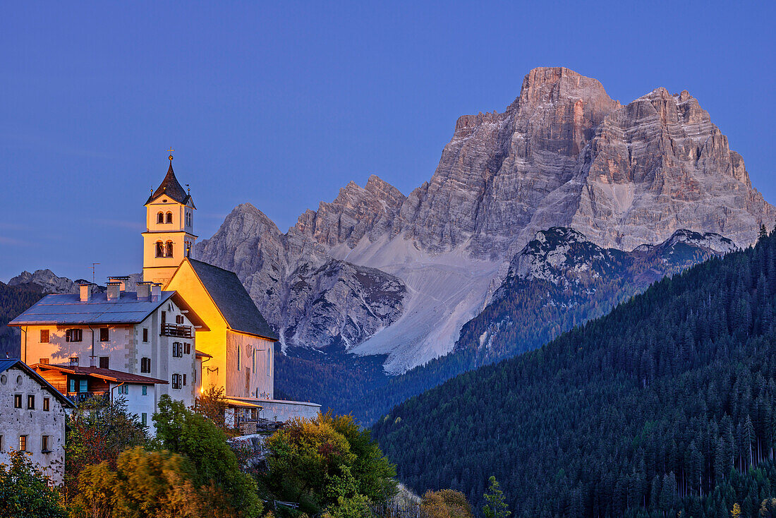 Illuminated church of Colle San Lucia with Monte Pelmo, Colle San Lucia, Dolomites, UNESCO World Heritage Site Dolomites, Venetia, Italy