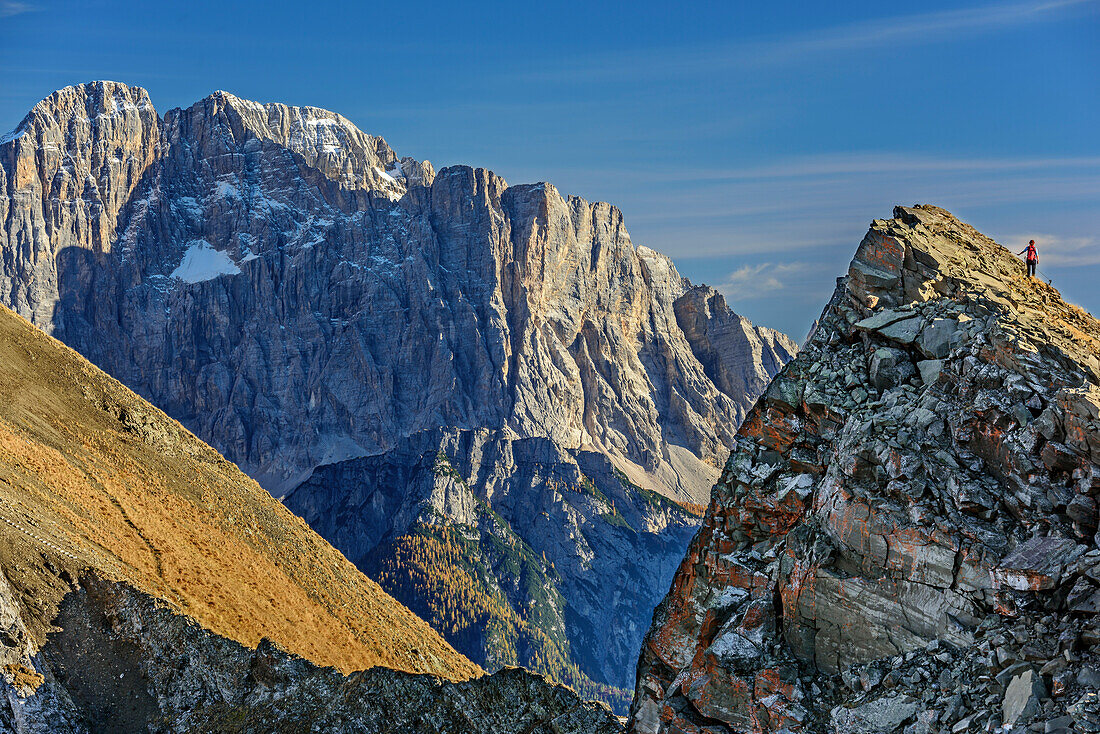 Woman hiking ascending towards Col di Lana, Civetta in background, Col di Lana, Dolomites, UNESCO World Heritage Site Dolomites, Venetia, Italy