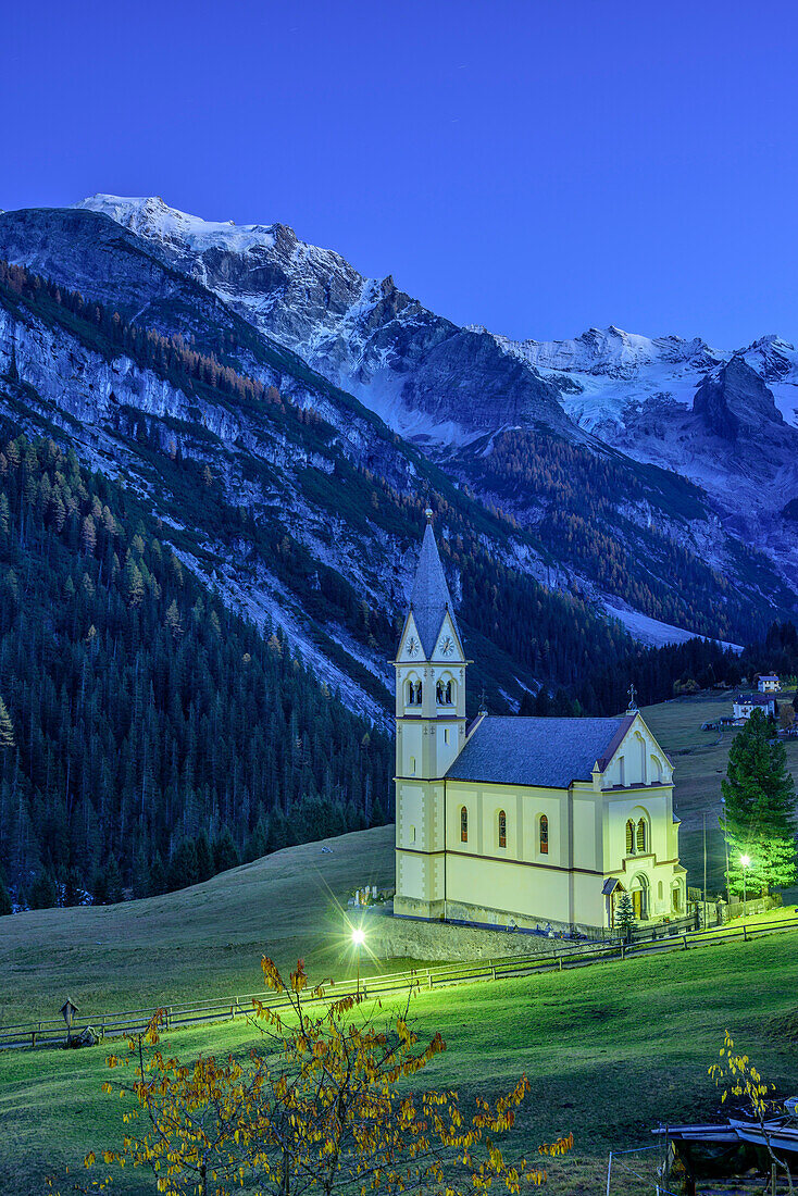 Illuminated church of Trafoi with Trafoier Eiswand in background, Trafoi, Ortler group, South Tyrol, Italy