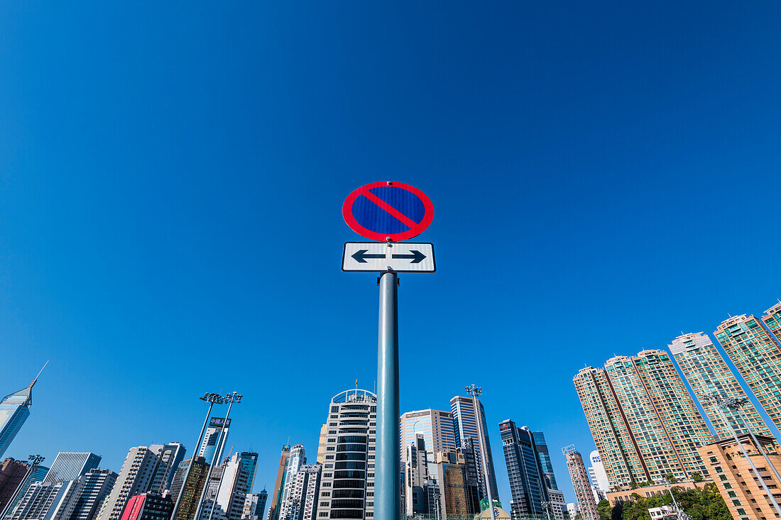 A no stopping sign in front of the skyline of high-rise buildings at Happy Valley Racecourse, Hong Kong, China, Asia