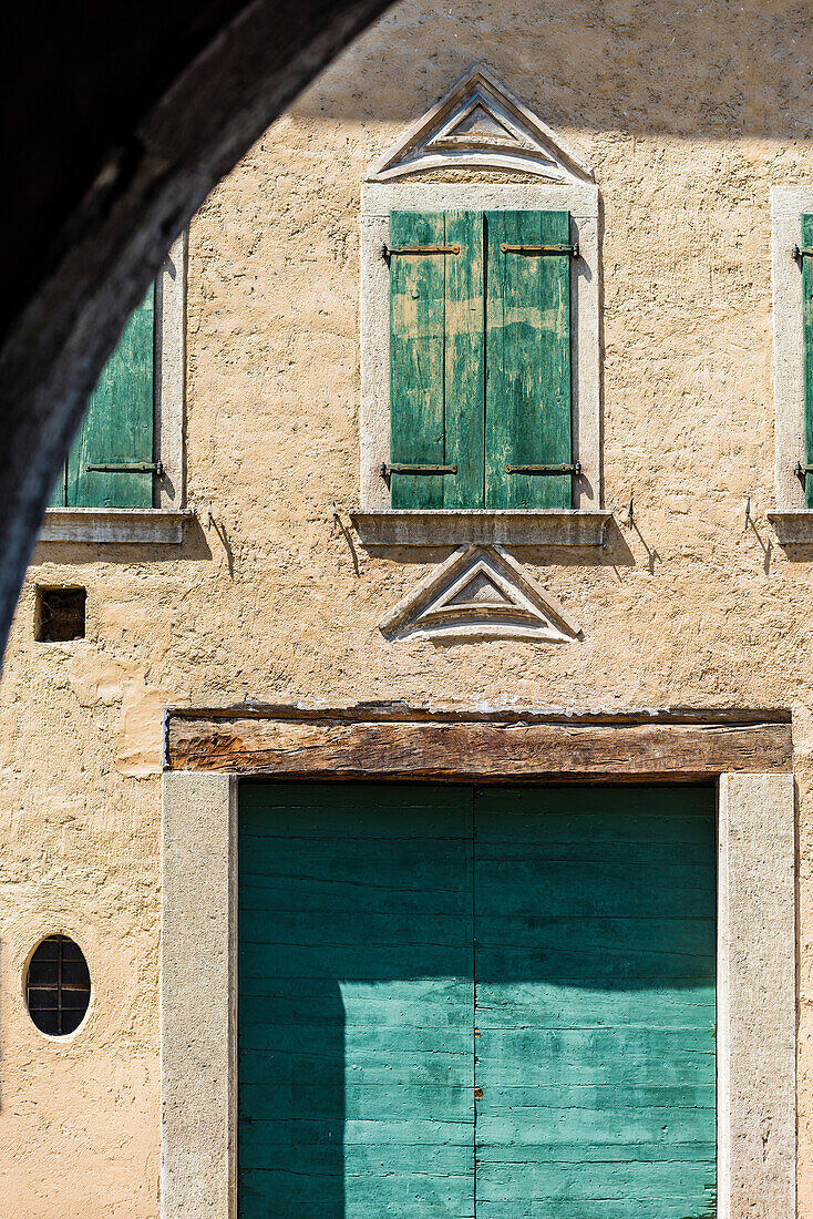 Eine Alte Hausfassade mit Fensterläden in einem kleinen Dorf an der Weinstraße, Margreid, Südtirol, Alto Adige, Italien