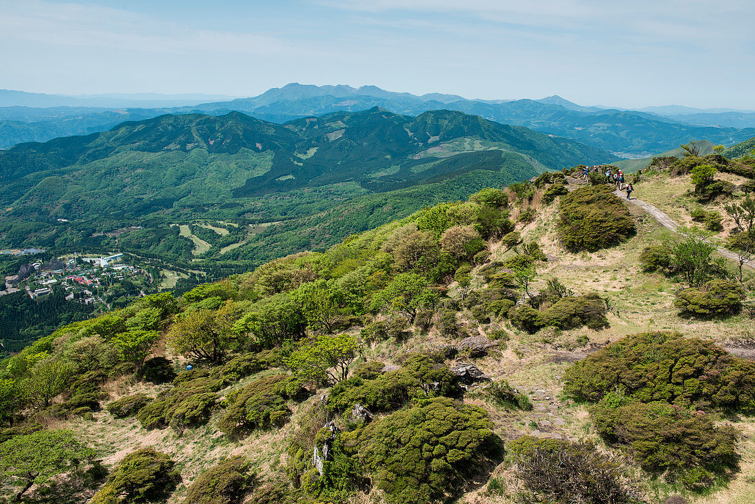 Tourists hike on hillside near gondola terminal, Beppu, Kyushu island, Oita, Japan, Asia