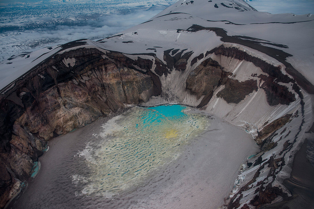 Aerial of the caldera of Maly Semyachik stratovolcano with its acidic crater lake seen from helicopter, near Petropavlovsk-Kamchatsky, Kamchatka, Russia, Asia