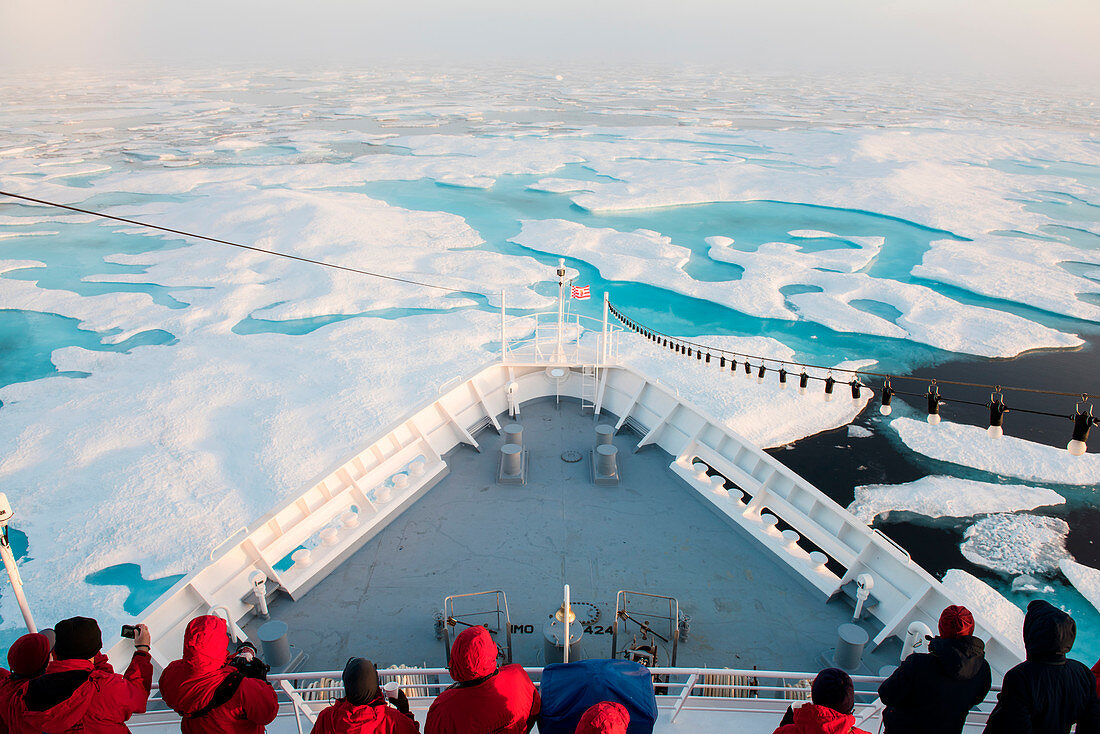 Passengers of the expedition cruiseship MS Bremen (Hapag-Lloyd Cruises) gather in early morning on the decks to view the edge of the pack-ice, near Prince of Wales Island, Nunavut, Canada, North America
