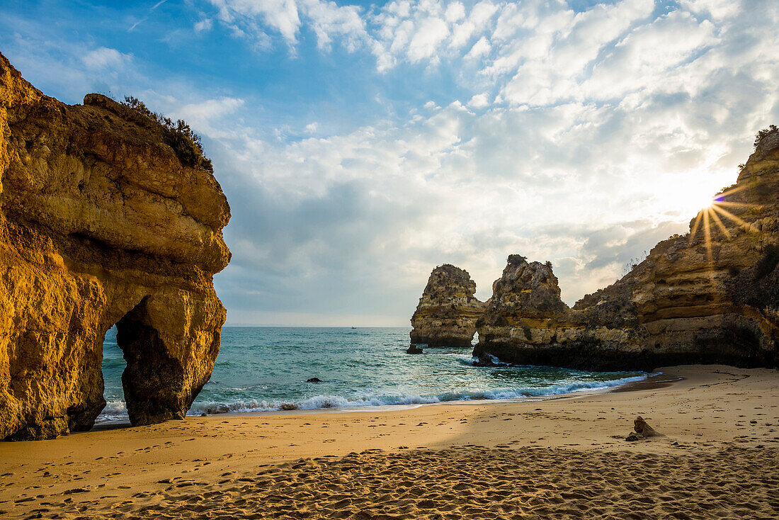 Rocky coast with beach and red rocks, Praia do Camilo, Lagos, Algarve, Portugal