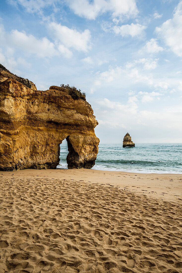 Rocky coast with beach and red rocks, Praia do Camilo, Lagos, Algarve, Portugal