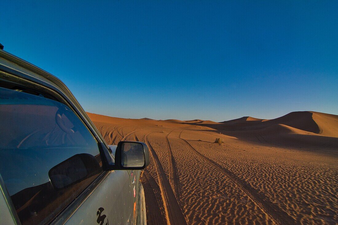 With a four-wheel drive in the desert driving over the dunes, Erg Chegaga, Sahara, Morocco