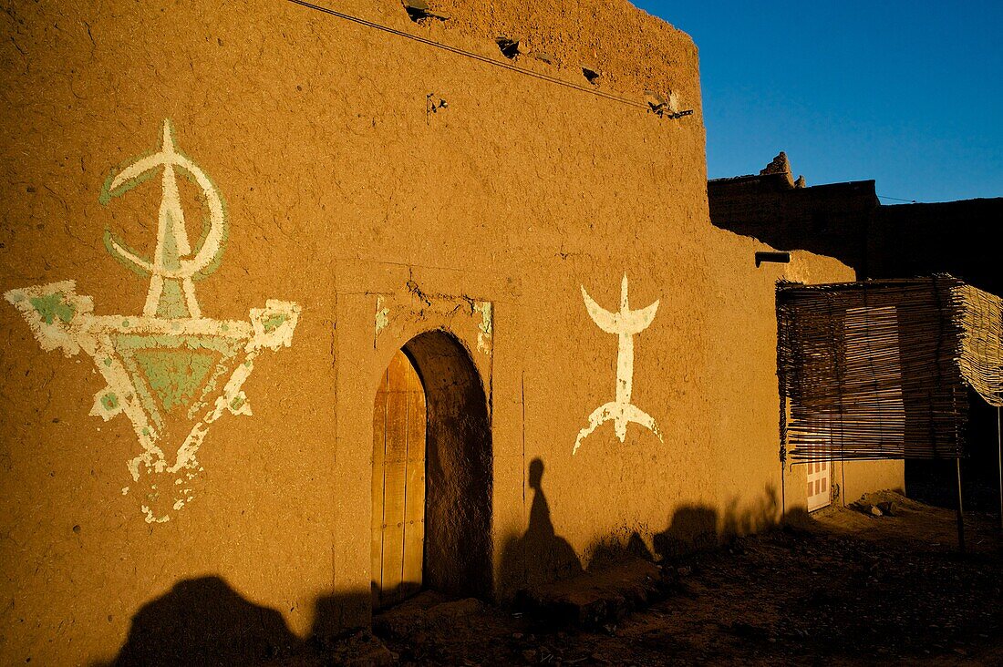 The Ksar Tissergate in the Draa Valley, near Zagora, Berber paintings and signs on the mud wall, Sahara, Morocco