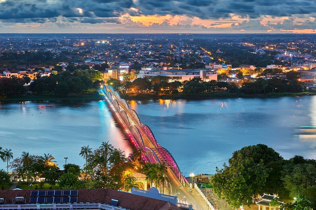 Truong Tien Bridge (designed by Gustave Eiffel) illuminated at dusk. Hue, Vietnam.