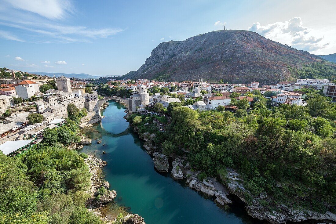 Aerial view on Mostar Old Town and Stari Most (Old Bridge) over Neretva river, Bosnia and Herzegovina. Hum Hill on background.