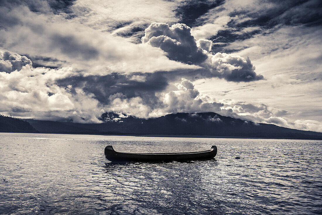 USA, Alaska, Homer, China Poot Bay, Kachemak Bay, a large canoe resting in the waters off of Kachemak Bay Wilderness Lodge