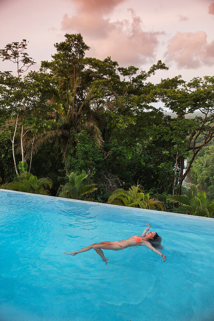 BELIZE, Punta Gorda, Toledo, Belcampo Belize Lodge and Jungle Farm, a guest enjoying all the amenities of the Ridge Suite, which offers stunning views, a private screened porch, outdoor soaking tubs and access to a salt water infinity pool