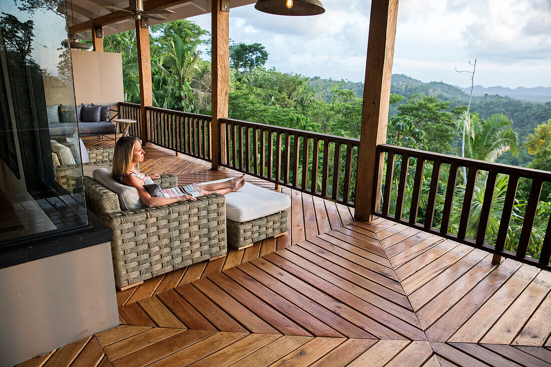 BELIZE, Punta Gorda, Toledo, Belcampo Belize Lodge and Jungle Farm, a guest enjoying all the amenities of the Ridge Suite, which offers stunning views, a private screened porch, outdoor soaking tubs and access to a salt water infinity pool