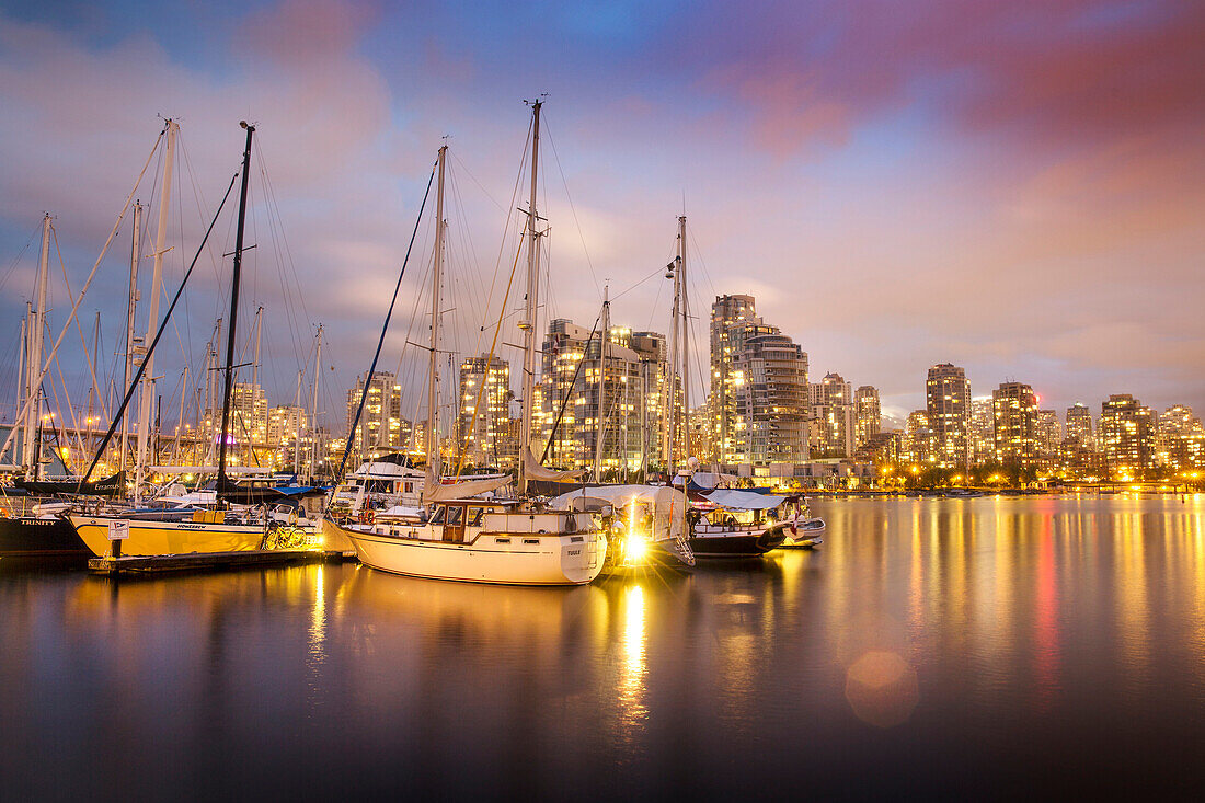 CANADA, Vancouver, British Columbia, looking across False Creek towards Yaletown and Davie Village at night, view from Charleson Park