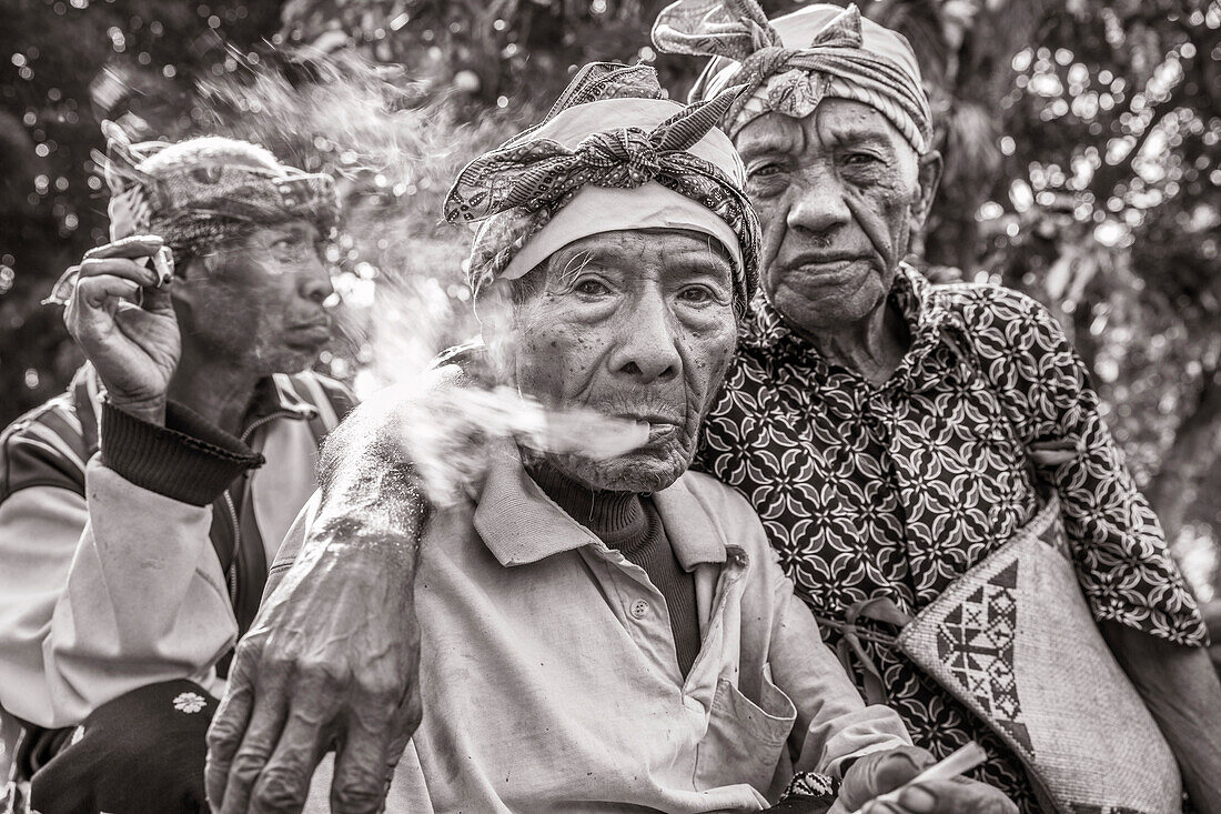 INDONESIA, Flores, 100 year old elder Wilhelmus Etu has a smoke with his friends, in Kampung Tutubhada village in Rendu