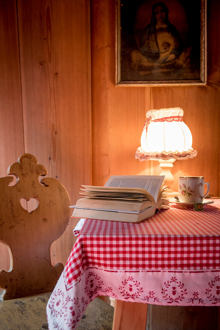 book, cup of tea, wooden room, traditional decoration, winterly interior, warmness, the Alps, South Tyrol, Trentino, Alto Adige, Italy, Europe