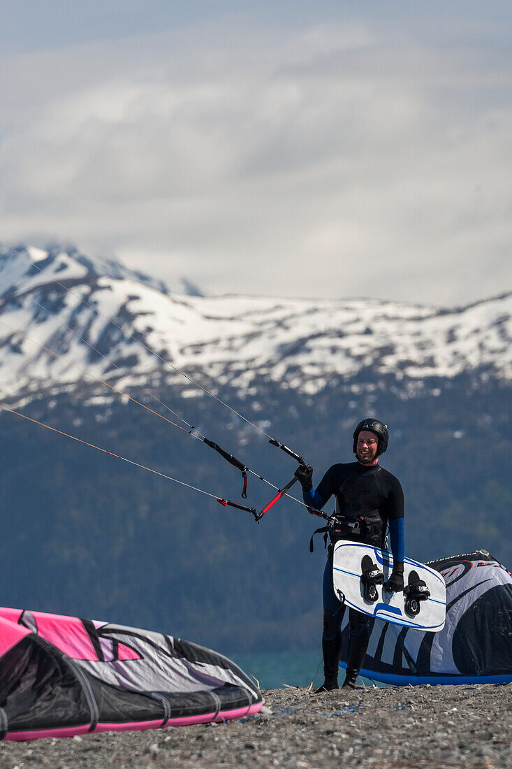 Kite Surfer With Board And Holding Kite On The Beach Of Homer, Southcentral Alaska, USA