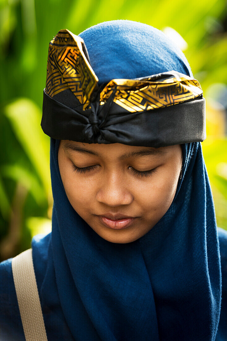 A Young Balinese Woman Poses At A Hindu Ceremony; Bali, Indonesia