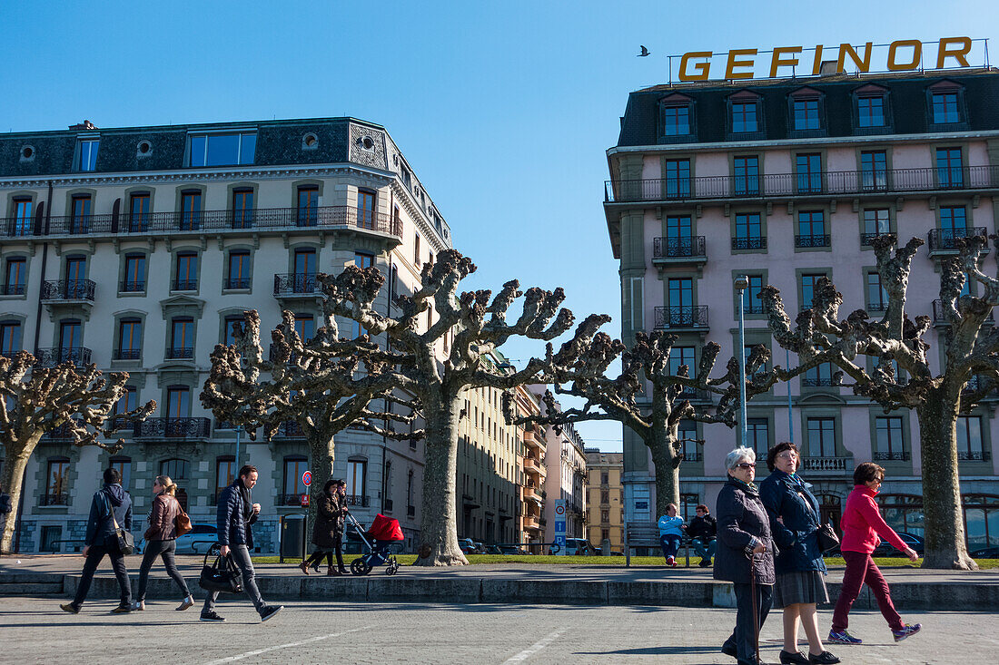 Pedestrians Walking On The Geneva Waterfront; Geneva, Switzerland