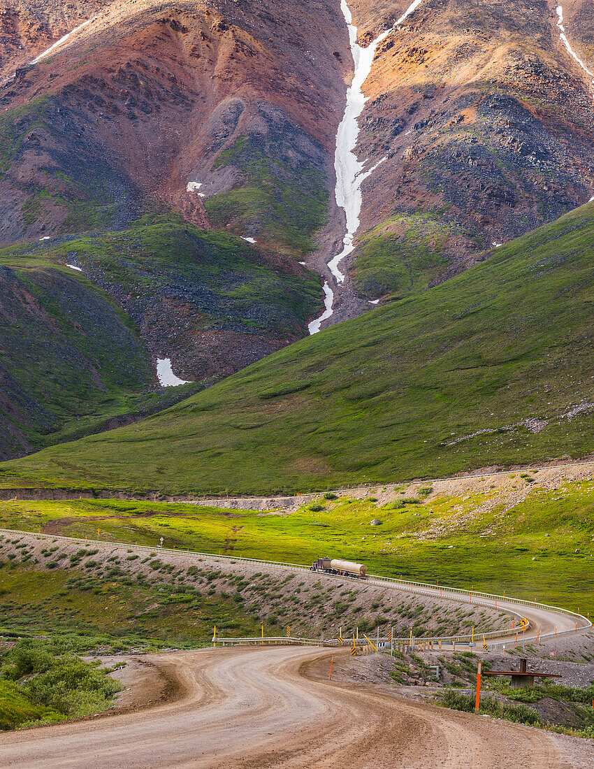 A semi-truck begins the ascent through Atigun Pass along the Dalton Highway; Alaska, United States of America