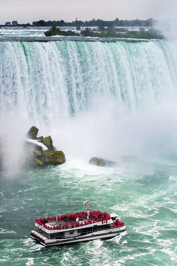 Close-up of Niagara Falls with tourist boat going towards the falls; Niagara Falls, Ontario, Canada