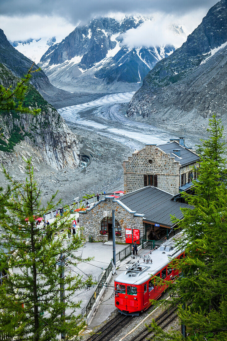 Montenvers train at Mer de Glace Station overlooks glacier and Grandes Jorasses; Chamonix-Mont-Blanc, Haute-Savoie, France
