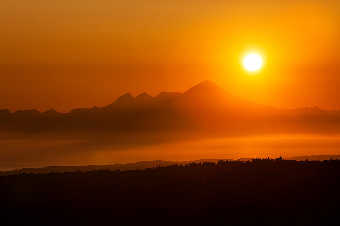 Glowing Sun During A Golden And Orange Sunset Over Kenai Mountains, Kachemak Bay State Park; Alaska, United States Of America