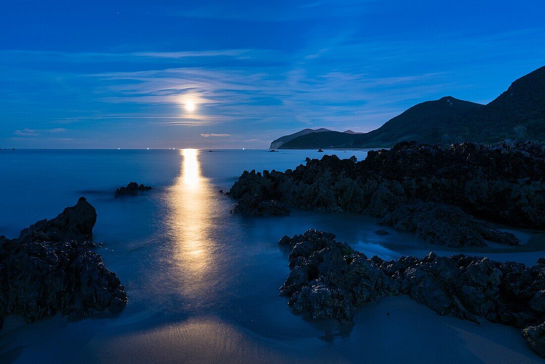 The Moon in Trengandin beach, Noja, Marismas de Santoña, Noja y Joyel Natural Park, Cantabrian Sea, Cantabria, Spain, Europe.