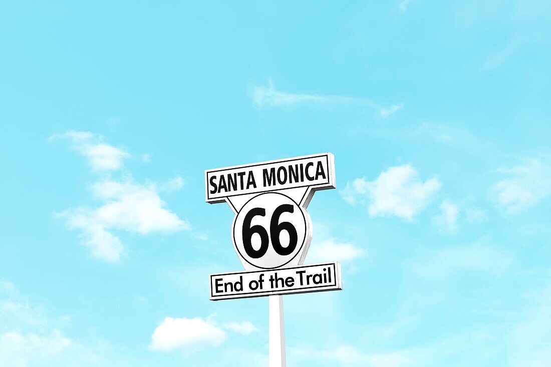 Minimalist scene of the Route 66 End of the Trail sign on Santa Monica Pier in California