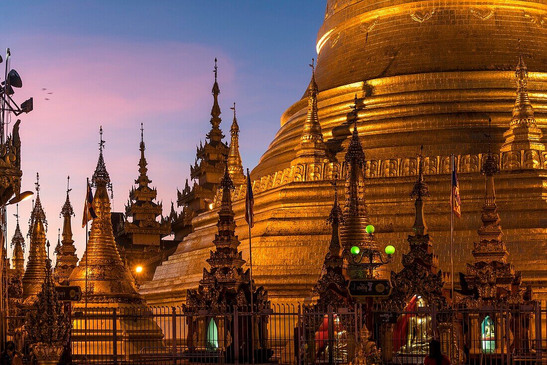 Stupas of the buddhist Shwemokhtaw Pagoda at dusk, Pathein, Myanmar, Asia.
