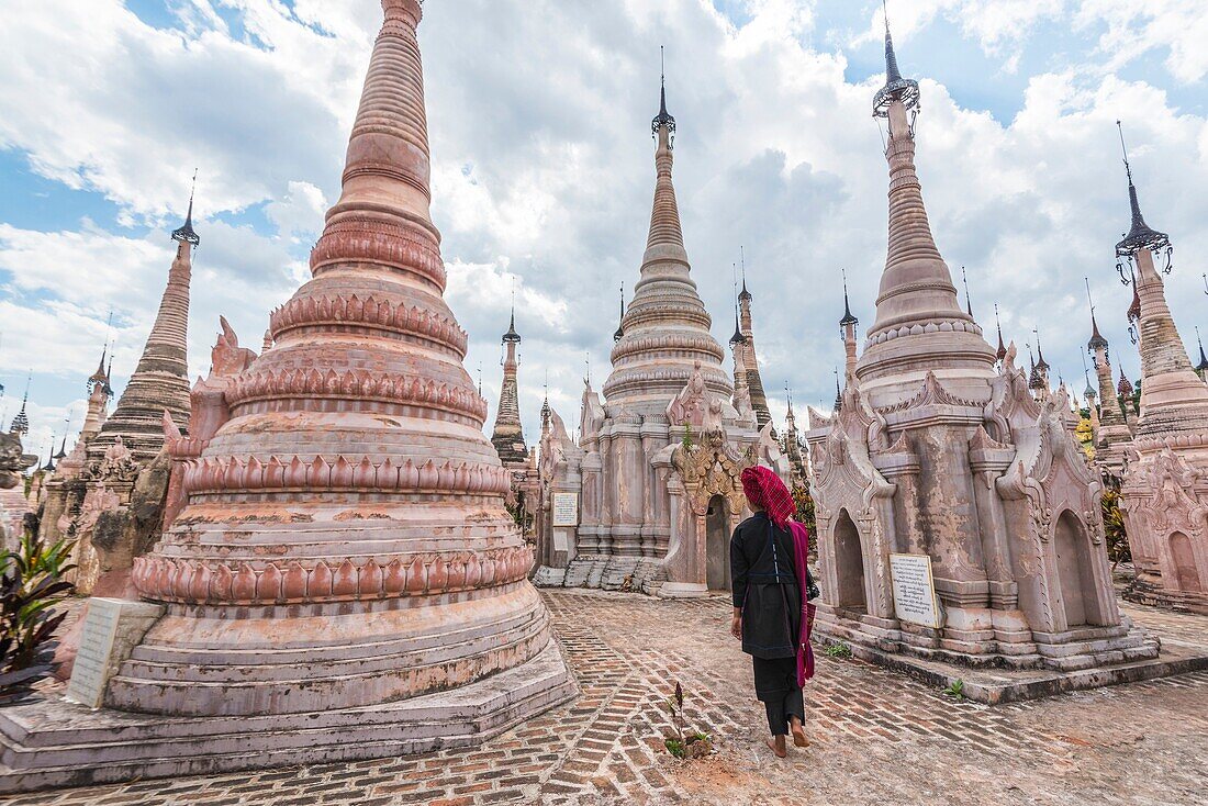 Kakku, Taunggyi, Shan State, Myanmar (Birmania). A woman walking between the 2478 stupas.