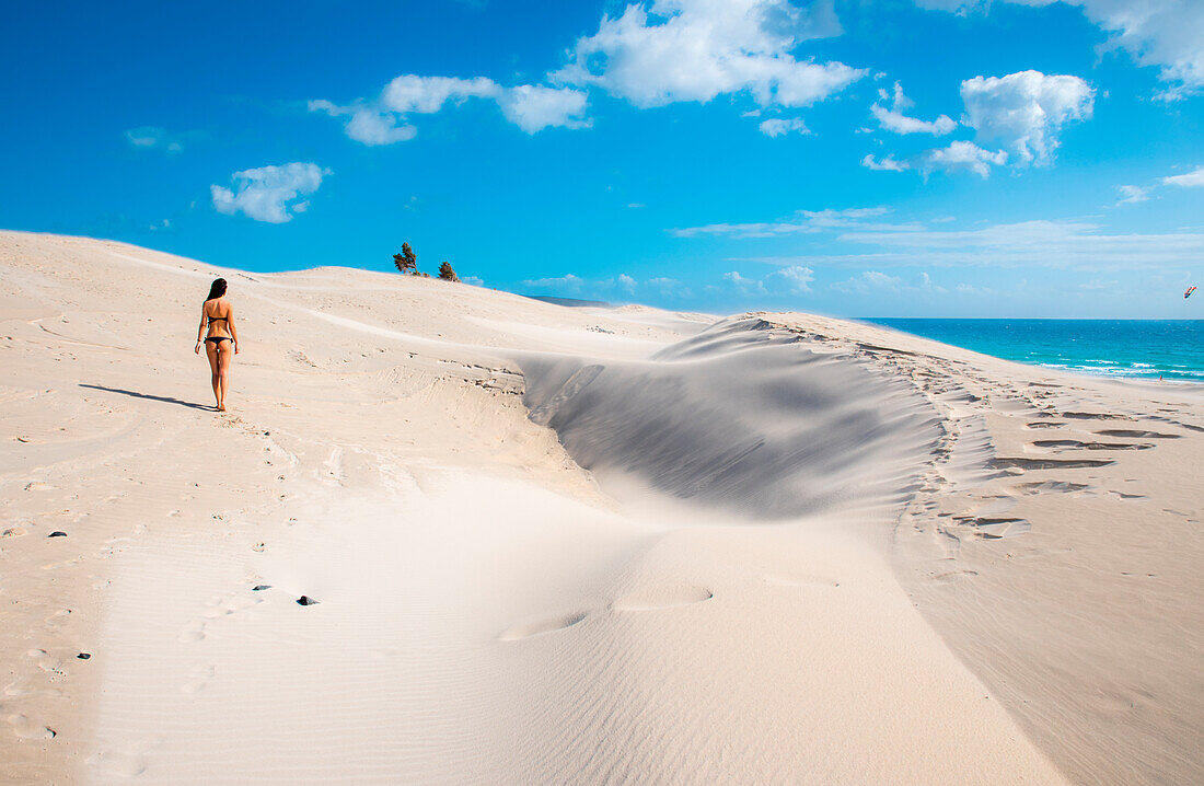 Woman walking on sand dunes, Is Arenas Biancas, Teulada, province of Cagliari, Sardinia, Italy