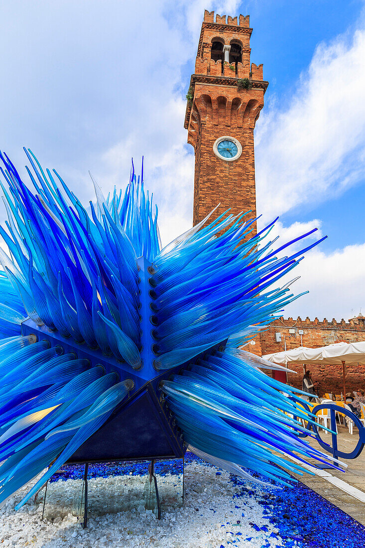 Glass sculpture under the bell tower of Murano, Venice, Veneto, Italy