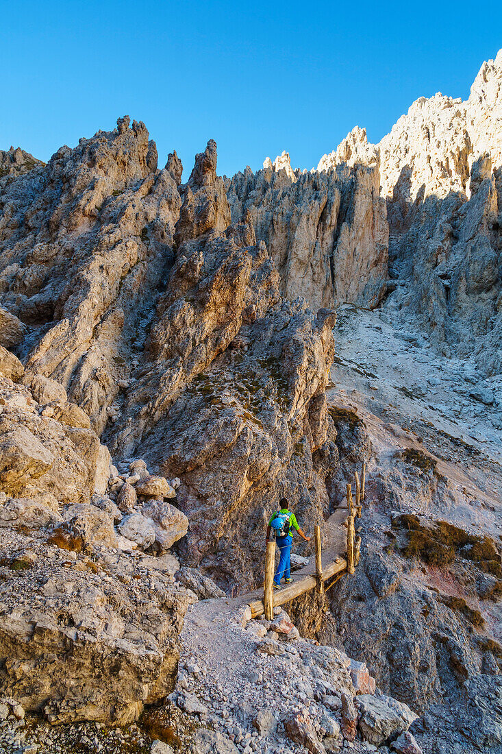 An Hiker along pathways to Forcella Mezdì, Odle group, Val Gardena, Tretino Alto Adige, Italy