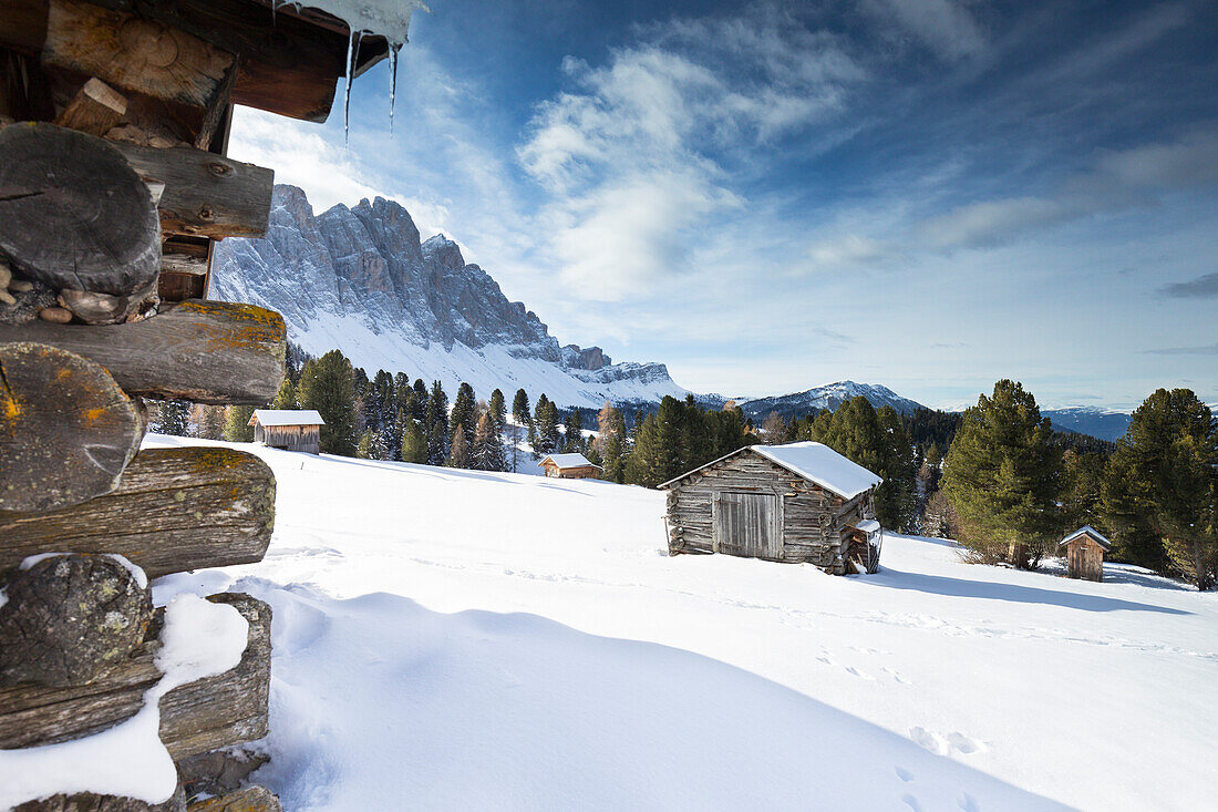 a view of several huts with the Geisler Group in the background from the Gampen Alm in Villnössertal, Bolzano province, South Tyrol, Trentino Alto Adige, Italy