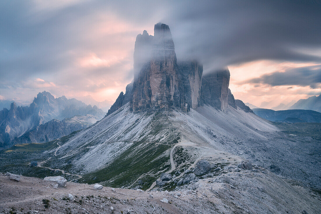 Sunset with clouds on Tre Cime di Lavaredo as seen from Lavaredo fork, Sexten Dolomites, Italy