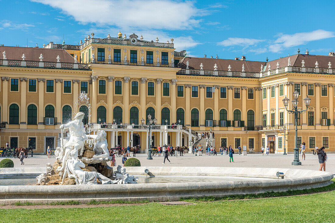 Vienna, Austria, Europe, The Schönbrunn Palace at sunrise, A fountain in the forecourt with the sculptures Galicia, Volhynia, and Transylvania