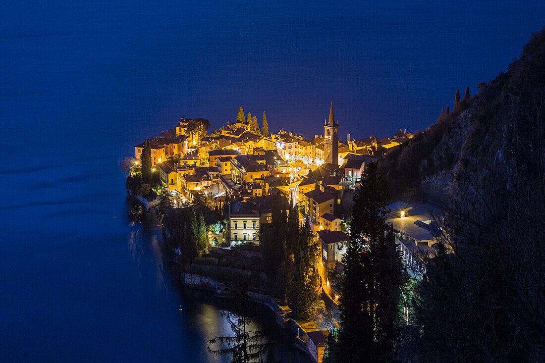 Como lake, provence of Lecco, the lights of Varenna village by night. Lombardy, Italy