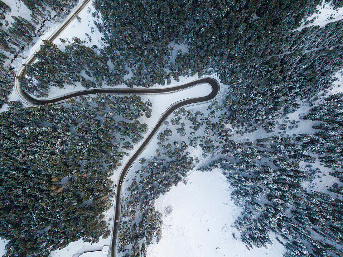 Lake of Carezza, Bolzano province, Trentino Alto Adige, Italy, The frozen Lake of Carezza with a mountain road view from top